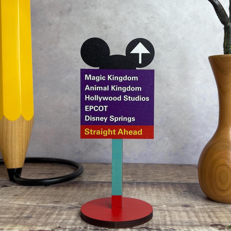 A wooden desk stand with an image of a Road Sign.