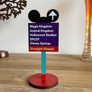 A wooden desk stand with an image of a Road Sign.