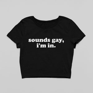 Peut inclure: T-shirt noir à manches courtes et texte blanc "sounds gay, i'm in."