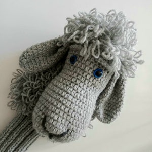 May include: Gray crocheted golf club head cover shaped like a poodle with blue eyes.