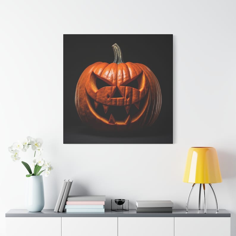 May include: A carved orange pumpkin with a scary face on a black background. The pumpkin has a wide, toothy grin and two small eyes.