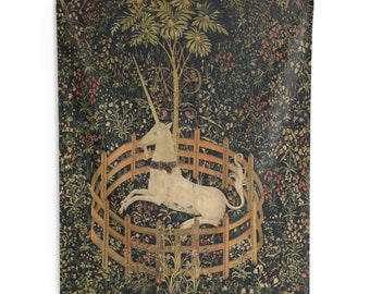 May include: A white unicorn with a golden horn is trapped in a circular wooden fence. The unicorn is surrounded by a lush green forest with colorful flowers and a large green tree in the background.