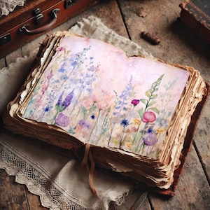 May include: An open antique book with aged, textured pages. The pages display a watercolour painting of colourful wildflowers in shades of pink, purple, and blue. The book is bound in brown leather and rests on a wooden surface.