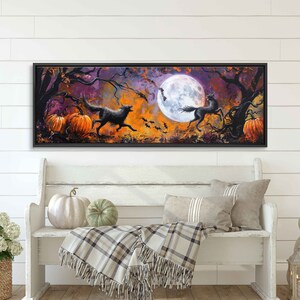 May include: A long, horizontal painting of a spooky forest scene with a full moon, bats, pumpkins, a wolf, and a horse. The painting is framed in black and set against a white wall.