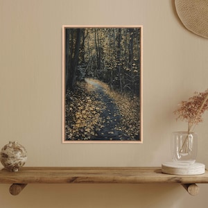 May include: A framed painting of a path through a forest with fallen leaves in shades of gold and brown. The path winds through the trees, which are dark and shadowy. The painting has a rustic and autumnal feel.