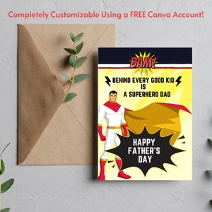 May include: A Father's Day card featuring a superhero illustration. The card has a yellow background with a black speech bubble that says "BAM!" and a red and gold cape. The text on the card reads "Behind every good kid is a superhero dad. Happy Father's Day."
