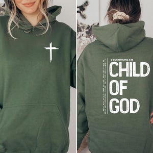 May include: A green hooded sweatshirt with a white cross on the front and the text "CHILD OF GOD" and "2 Corinthians 6:18" on the back.