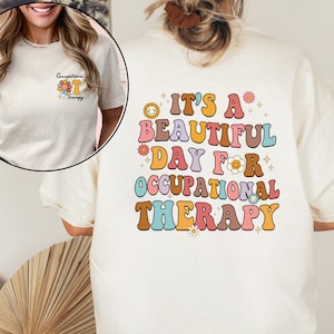 May include: A white t-shirt with a colorful retro design that says "It's a beautiful day for occupational therapy".