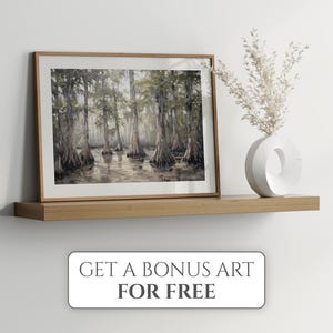 May include: A framed watercolour painting of a swamp scene with tall trees and still water. The painting is on a wooden shelf with a white vase and dried flowers.