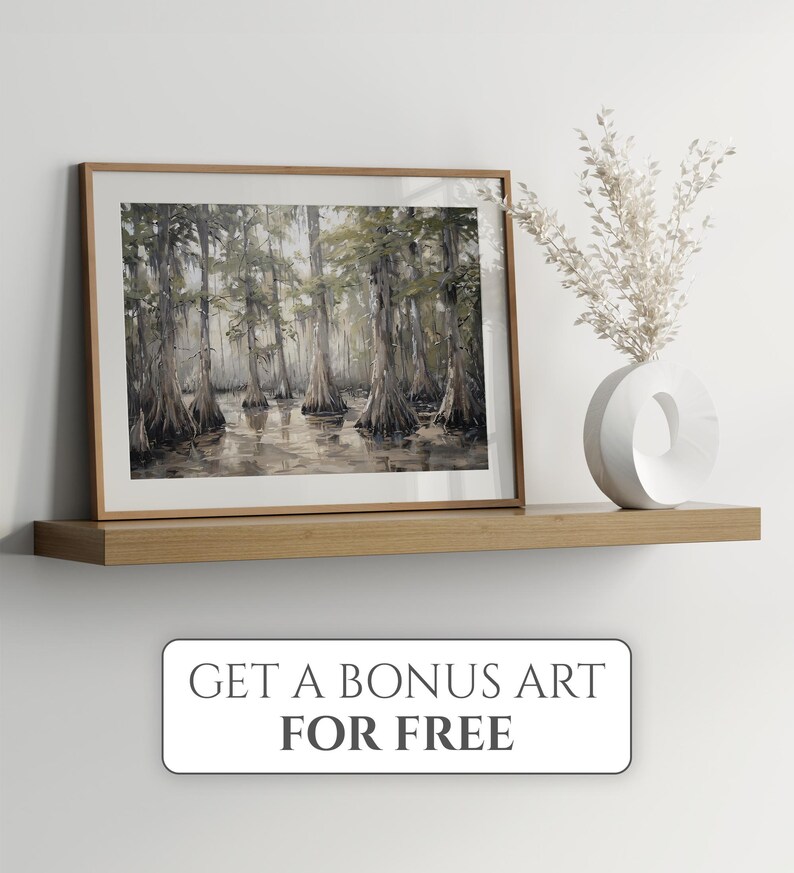 May include: A framed watercolour painting of a swamp scene with tall trees and still water. The painting is on a wooden shelf with a white vase and dried flowers.