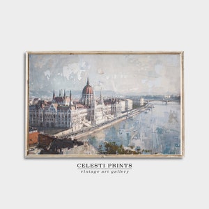 Puede incluir: Una pintura vintage del edificio del Parlamento h&uacute;ngaro en Budapest, con un r&iacute;o en primer plano y un puente en la distancia. La pintura est&aacute; realizada en una paleta de azules, grises y marrones apagados, con un toque de rojo en el edificio.