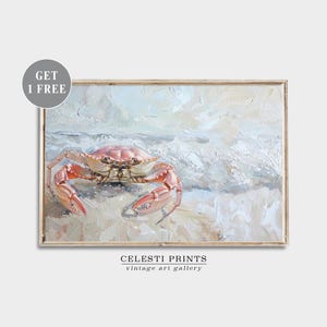 May include: A painting of a red crab on a sandy beach with white foamy waves in the background. The painting is framed in a light wood frame. The text "Celesti Prints vintage art gallery" is at the bottom of the painting.