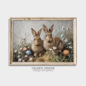 May include: Two brown rabbits sitting in a field of white flowers with colorful Easter eggs. The rabbits are looking at the viewer. The background is a light blue sky.