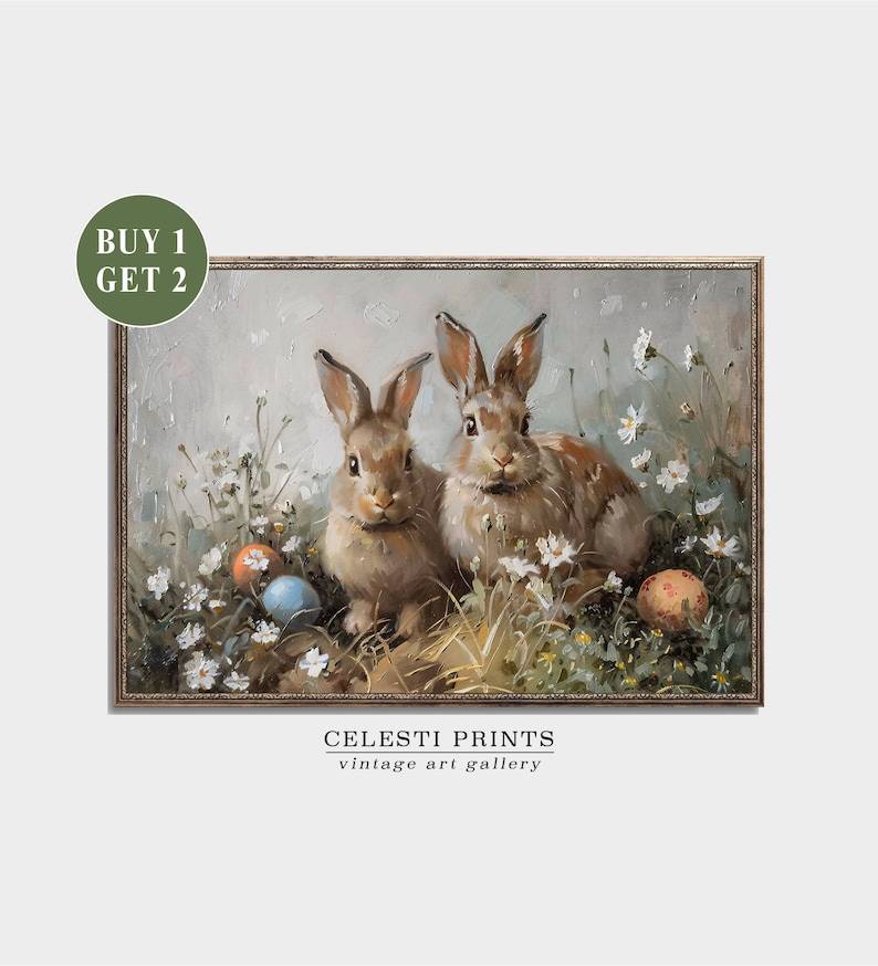 May include: Two brown rabbits sitting in a field of white flowers with colorful Easter eggs. The painting is framed in gold.