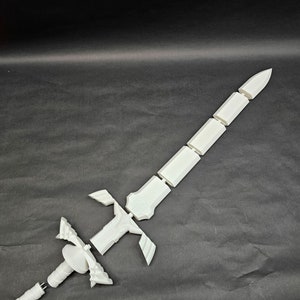 May include: A white, disassembled sword, likely 3D-printed, with a detailed hilt and segmented blade. The sword's components are arranged against a dark background, showcasing its design and construction. The blade is approximately 24 inches long.