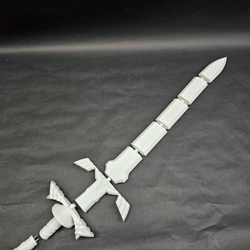 May include: A white, disassembled sword, likely 3D-printed, with a detailed hilt and segmented blade. The sword's components are arranged against a dark background, showcasing its design and construction. The blade is approximately 24 inches long.