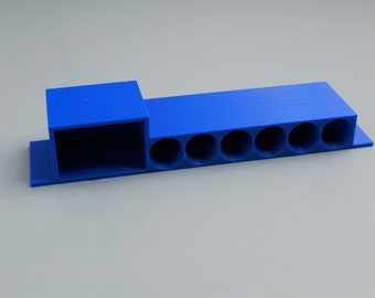 May include: A blue plastic organiser with a rectangular compartment and six round slots.