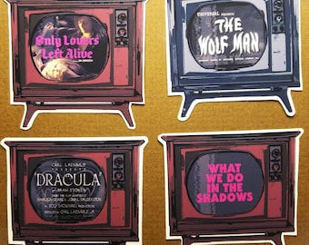 May include: Four vintage television sets with different movie posters on the screen. The posters are for the movies "Only Lovers Left Alive", "The Wolf Man", "Dracula", and "What We Do in the Shadows".