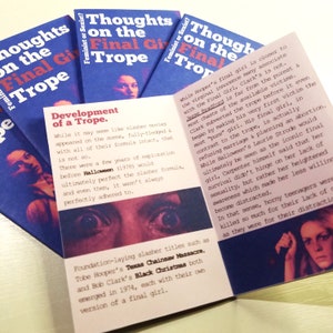 May include: A close-up of a book with the title "Thoughts on the Final Girl Trope" and text about the development of the trope in horror movies. The book is open to a page with a photo of a woman's eyes and a photo of a woman's face. The book is on a light brown surface.