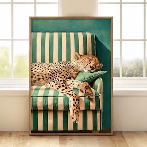 May include: A framed art print depicts a sleeping cheetah on a striped green and beige armchair. The cheetah's fur is spotted, and it rests on a green pillow. The background is a solid teal color, and the frame is a light brown.