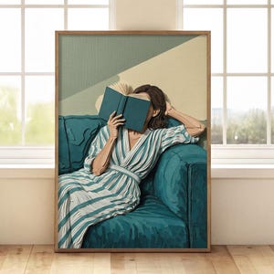 May include: A framed art print depicts a person reading a book while relaxing on a teal sofa. The person is wearing a striped robe. The artwork has a minimalist style with a color palette of teal, beige, and brown.