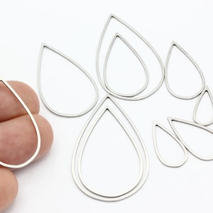 May include: A set of nine silver teardrop-shaped metal hoops of varying sizes. The hoops are made of a thin metal and are perfect for jewellery making.