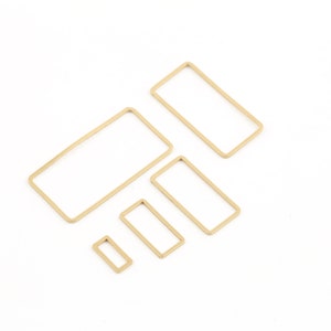 May include: Set of four gold-toned metal rectangular hoops of varying sizes.