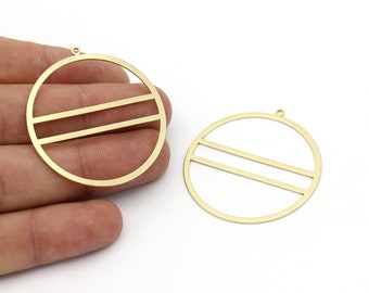 May include: Two gold-colored, circular pendant charms with a minimalist design. Each charm features a circle with two horizontal bars across the center. The charms have a small loop at the top for attaching to a chain or other jewelry component.