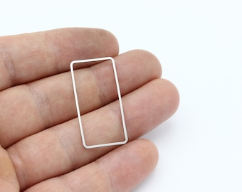 May include: A silver-coloured metal rectangle frame.