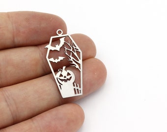May include: Silver-toned metal charm shaped like a coffin with a jack-o'-lantern, bats, and tree branches cut out.
