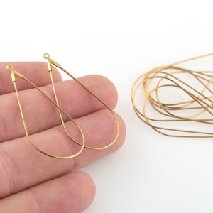 May include: Gold teardrop shaped earring wires, two individual wires and a bundle of ten wires.