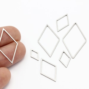 May include: A set of seven silver metal diamond-shaped frames of varying sizes.