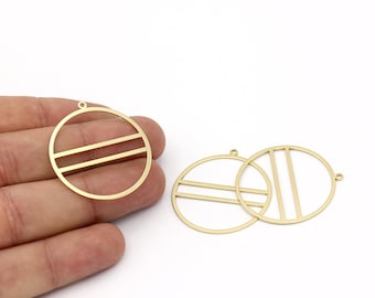 May include: Gold-colored metal circle pendants with horizontal and vertical bar designs. The pendants have small loops for attaching to jewelry. The image shows several pendants against a white background.