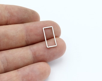May include: A silver-coloured rectangular frame with a smooth, polished finish. The frame is small and delicate, ideal for adding a touch of elegance to jewellery or crafts.
