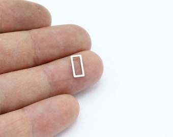 May include: A silver-toned metal rectangle jump ring with a smooth finish.