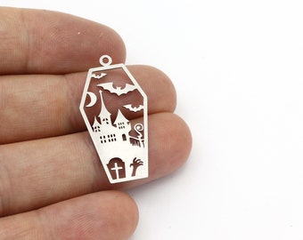 May include: Silver metal charm shaped like a coffin with a cutout design of a haunted house, bats, and a crescent moon.