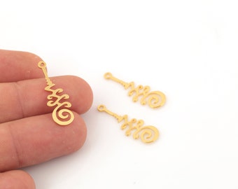 May include: Three gold-coloured metal charms with a spiral design. The charms have a hole at the top for attaching to jewellery or other crafts.