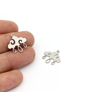 May include: Two silver metal charms shaped like clouds with raindrops hanging from them. The charms are approximately 2.5 cm in size.