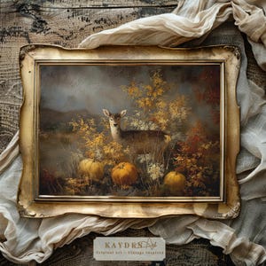 May include: Vintage-inspired framed art print featuring a deer in a forest scene with pumpkins and autumn foliage. The artwork has a gold ornate frame. The text "KAYDEN Art - Vintage Inspired" is at the bottom.