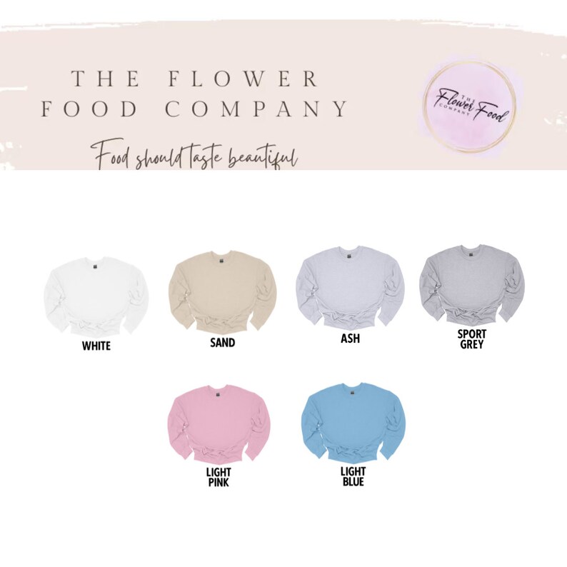 K&ouml;nnte beinhalten: Sechs verschiedene farbige Sweatshirts mit einem Bindedetail vorne. Die Farben sind wei&szlig;, sand, aschgrau, hellrosa, hellblau und sportgrau. Der Text "The Flower Food Company" befindet sich oben im Bild. Der Text "Food should taste beautiful" befindet sich unter dem Firmennamen.