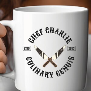 May include: White ceramic mug with a black and white logo that says "Chef Charlie Culinary Genius" with the text "Estd 2023" on the mug.