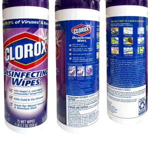 May include: A cylindrical container of Clorox Disinfecting Wipes. The container is white with a purple top and bottom. The label features the Clorox logo, product name, and information about killing viruses and bacteria. It contains 75 wet wipes, 1 lb 3.7 oz (559 g).