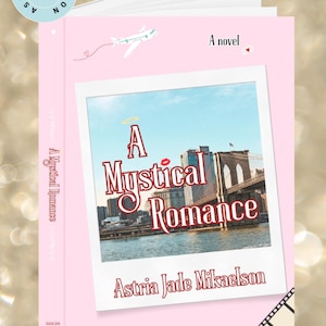 Puede incluir: Un libro de bolsillo rosa titulado "A Mystical Romance" de Astria Jade Mikaelson. La portada presenta una foto de paisaje urbano con el título en rojo y blanco, y la pregunta "Do You Believe in Fate?"