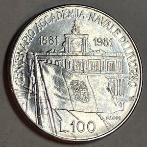 May include: A silver coin featuring a building with a flag and the text "CENTENARIO ACCADEMIA NAVALE DI LIVORNO 1881-1981". The coin also displays the value "L.100".