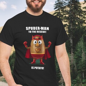May include: Black t-shirt featuring a cartoon potato dressed as a superhero with a red cape and the Superman logo. The text on the shirt reads "SPUDER-MAN TO THE RESCUE! IS POTATO!"