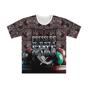 May include: A white t-shirt with a brown and black patterned design. The shirt features a graphic of billiard balls and cues with the text "Pressure is just a state of mind".
