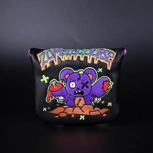 May include: Black golf club head cover with a purple zombie teddy bear graphic and the text "Zombie Curse".