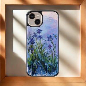 Peut inclure: Une coque de téléphone avec une peinture d'iris violets sur un fond de ciel bleu clair et violet. La coque a une bordure noire et une découpe pour l'appareil photo.