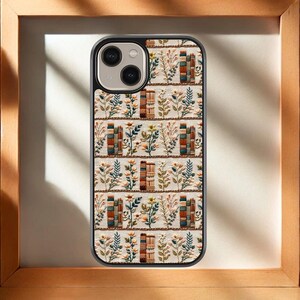 May include: A phone case with a white background and a repeating pattern of colorful books and flowers. The case has a black border and a camera cutout.