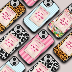May include: A set of eight phone cases with different patterns and designs. Each case features a white paper note with the text "Guest Check" and "Do it for the plot". The patterns include leopard print, black and white cow print, pink and white stripes, blue and white gingham, and a colorful abstract design.